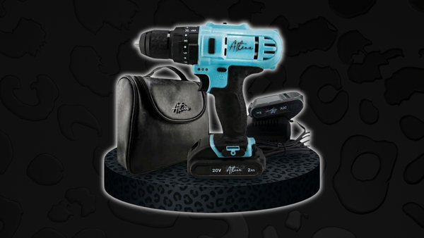 Aleah lightweight power tools for women, featuring a compact blue and black cordless drill, branded carrying case, and 20V battery displayed on a stylish leopard-print platform.