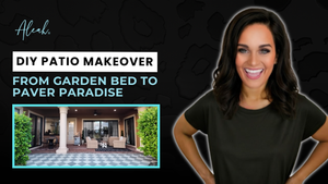 A stunning hero shot of a finished DIY patio makeover, showcasing a luxury backyard transformation with a high-contrast gray and white checkered paver design that replaces a neglected garden bed.