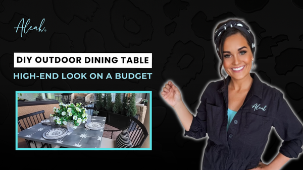 Thumbnail for a project that focuses on DIY outdoor dining table with a luxury dark gray floral tile top styled in a backyard sanctuary with matching black chairs and a planter pedestal base,.
